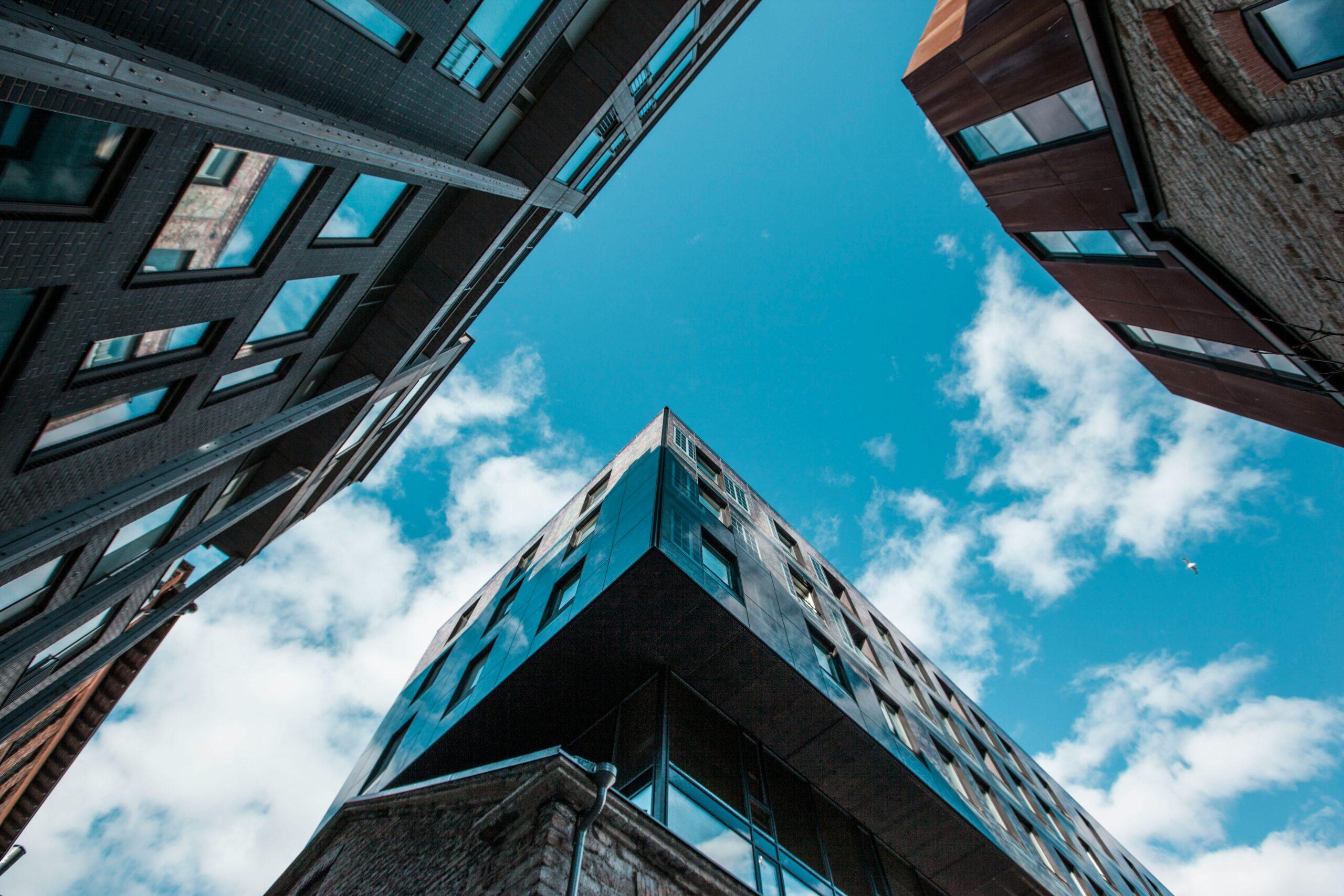 Offerings Upward view of modern architecture and clear blue sky in Tallinn, reflecting contemporary urban design.
